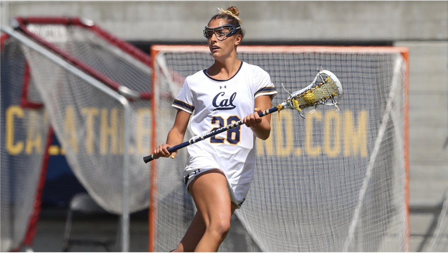 Woman in jersey holding lacrosse stick