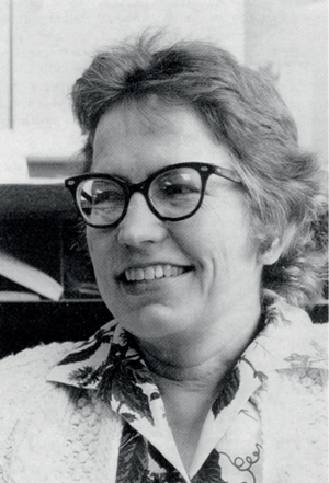 grayscale photo of Elizabeth Scott smiling in glasses and looking off into the distance
