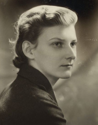  sepia toned photo of Elizabeth Huff in a black blazer, adamantly looking over her shoulder and off into the distance
